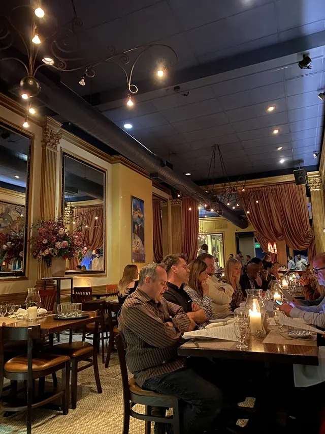 Guests enjoying dinner beneath the dining room ceiling lights