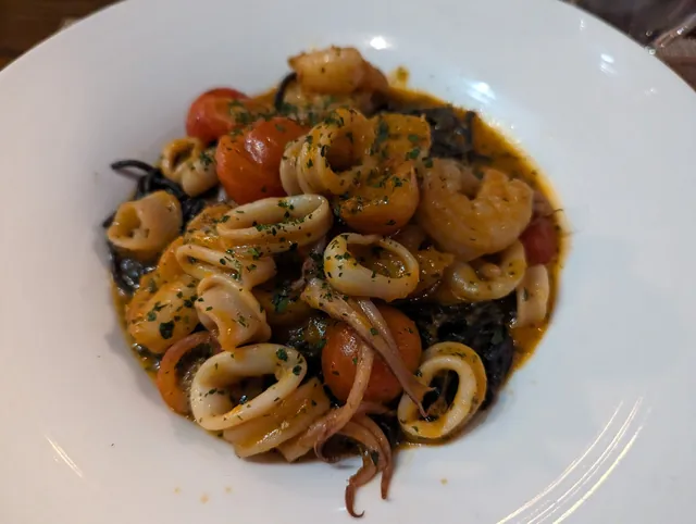 Shrimp and calamari with vegetables on a white plate